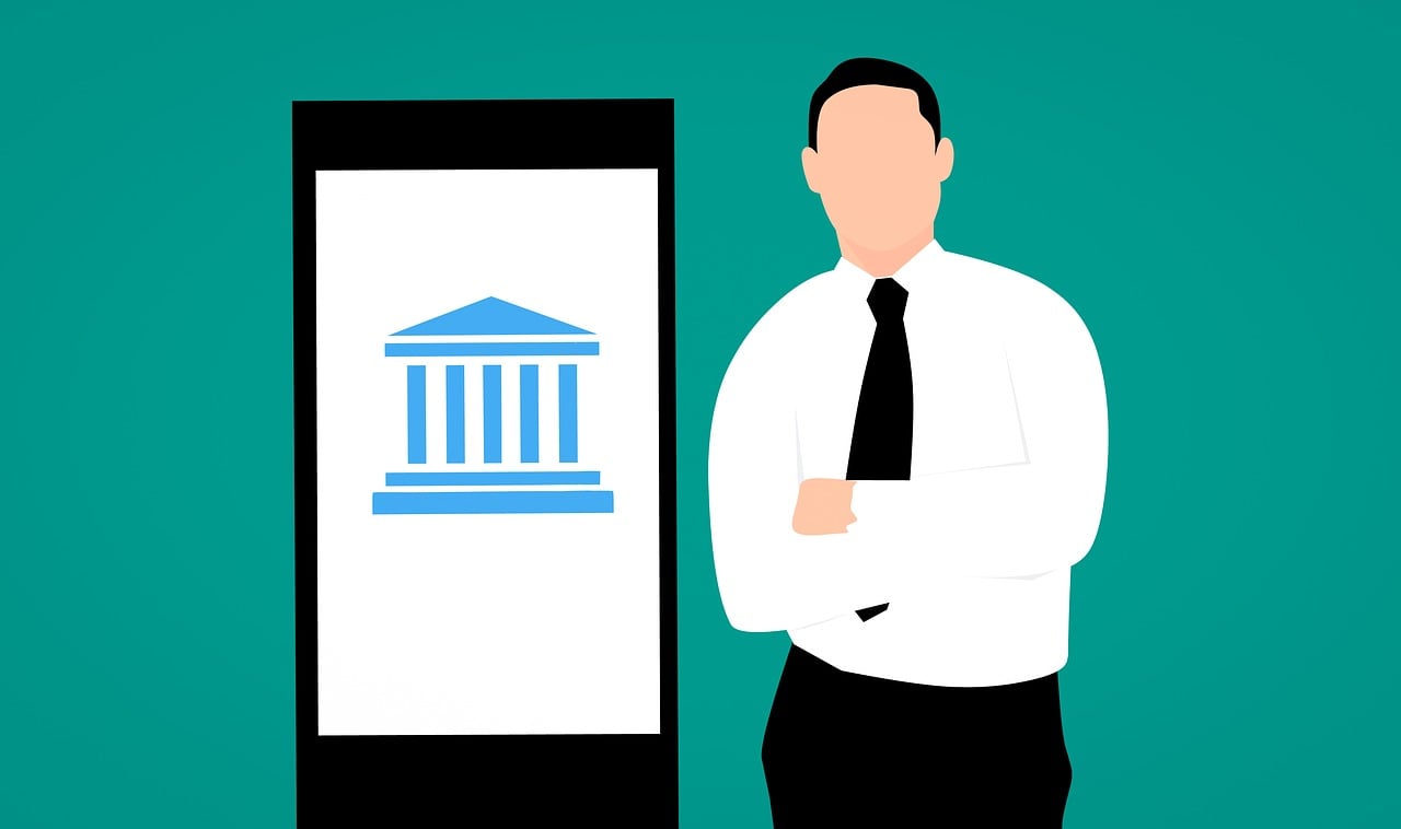 Mobile with a bank app next to a man standing with arms folded