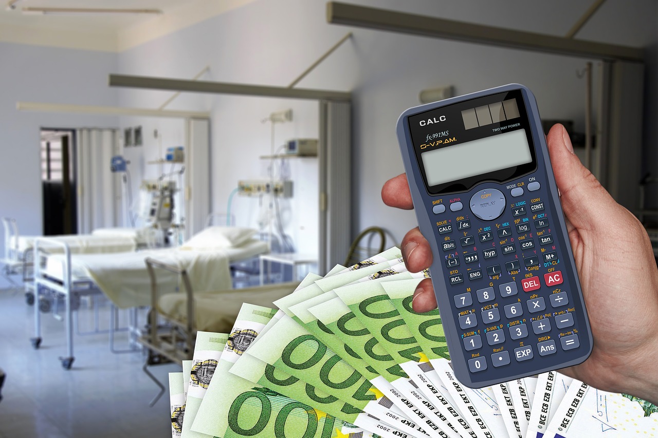 hand with a calculator and cash outside a hospital ward