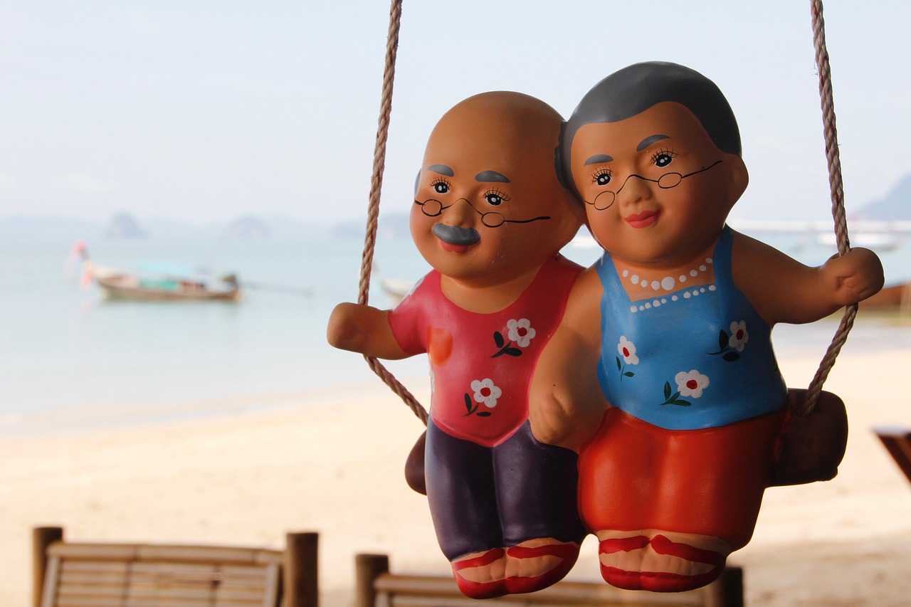 doll of old couple sitting on swing