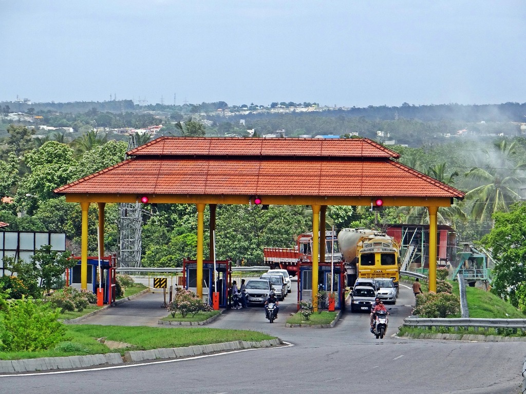 picture of a toll plaza with trucks and cars