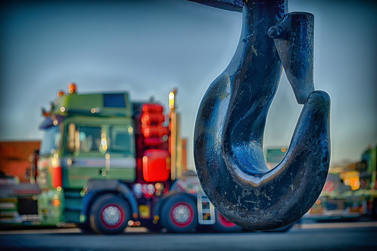 Crane hook with a big truck in the background