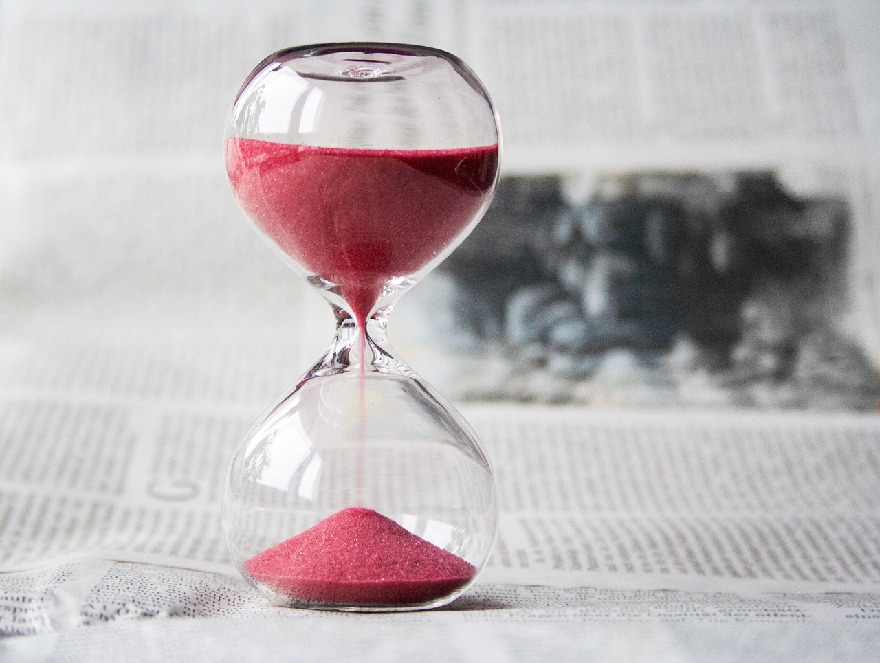 hourglass with pink sand