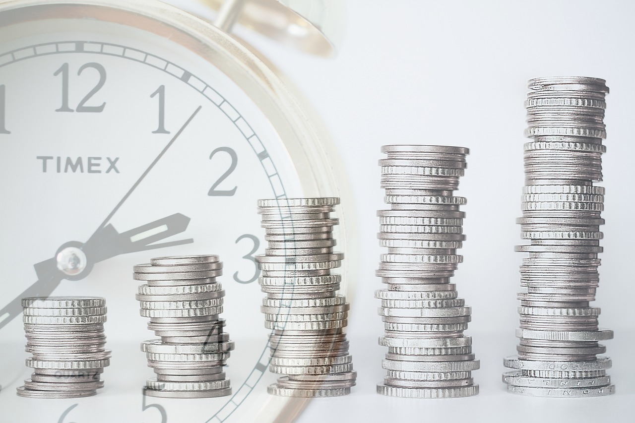 Increasing stacks of coins against a clock