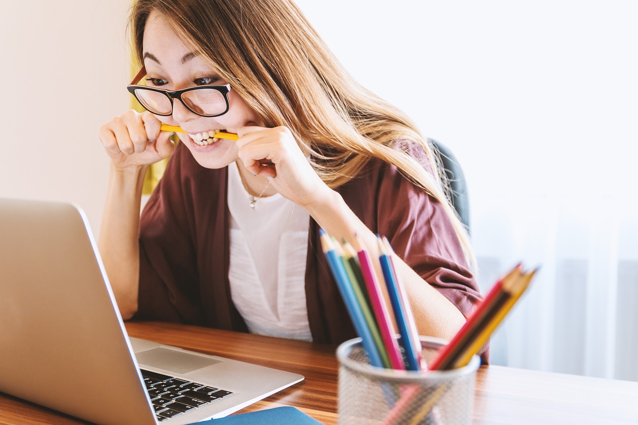 girl student, stack of pencils, laptop