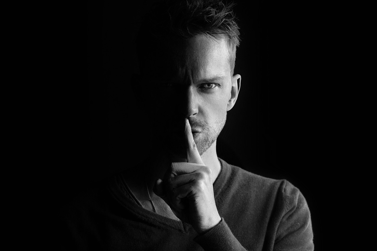 Man with secrete face - relates to AI-Washing Alert: How to Spot Fake AI Products and Services - Don't Be Fooled