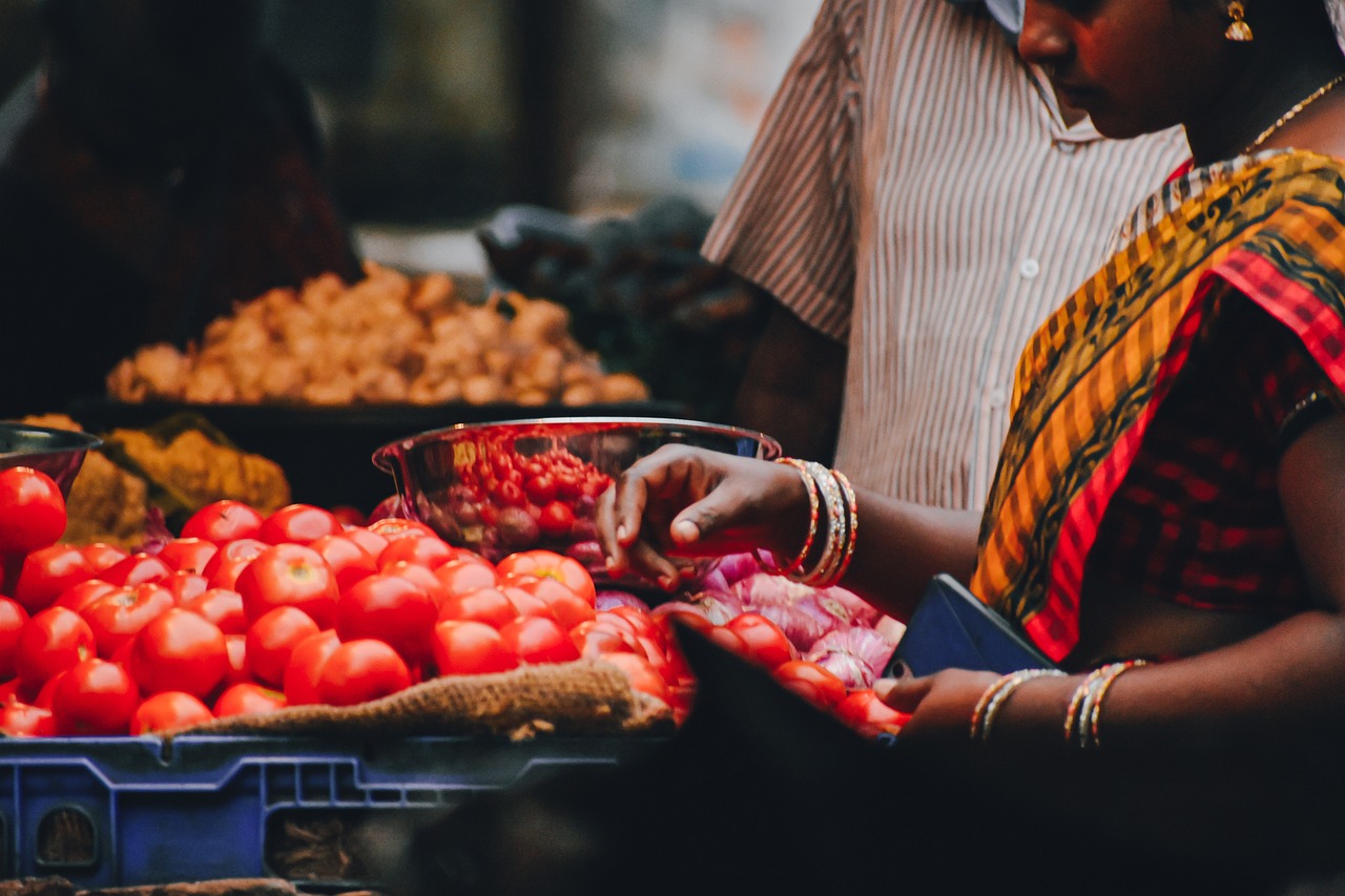 Indian women buying fresh produce from market -relates to Demand & Supply: How Markets Create What You Buy, Marketplace