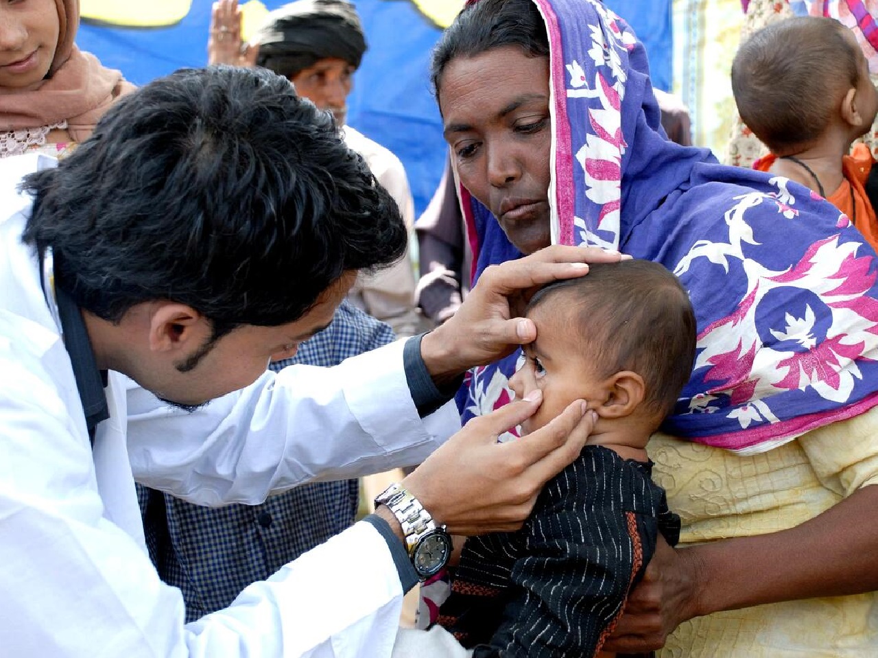 A Doctor examining a child by National Health Authority Card scheme
