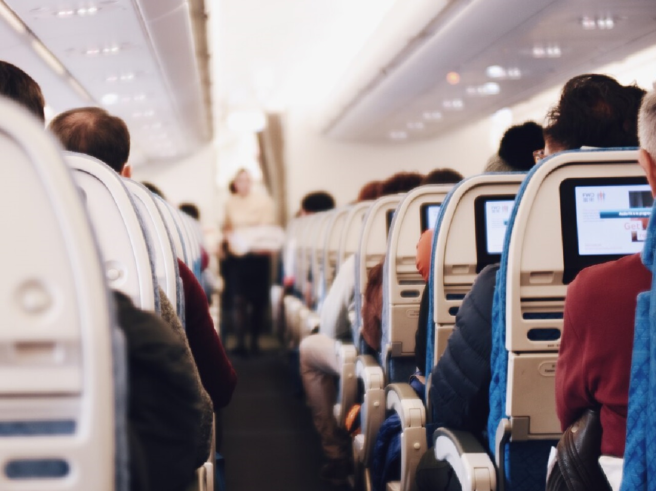 Internal view of an airplane full of passengers - travel allowance
