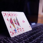 Poker cards in front of a computer