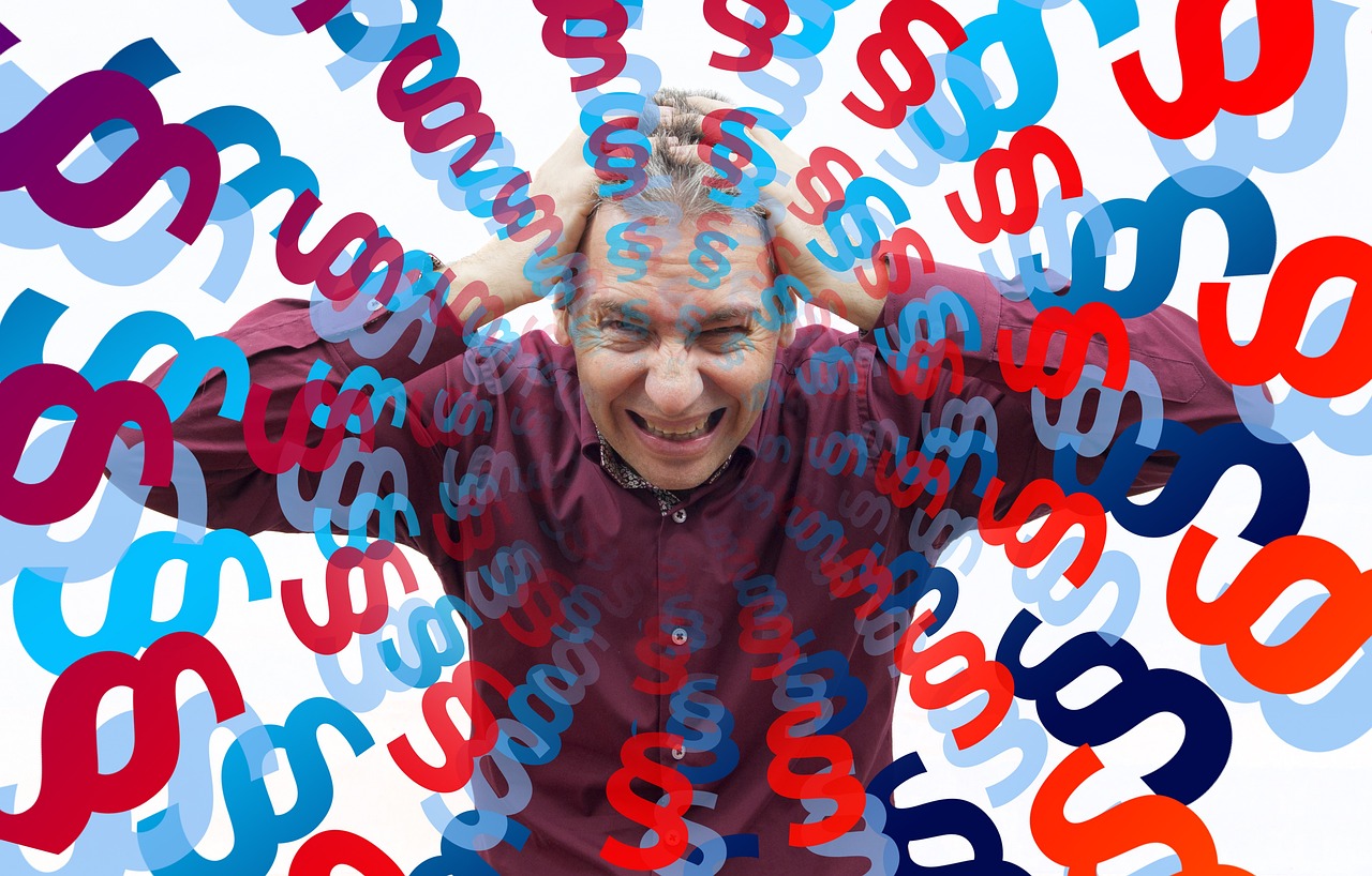man holding head because of stress