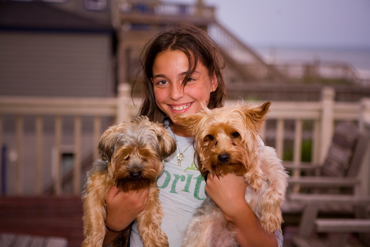 Girl holding two pet dogs