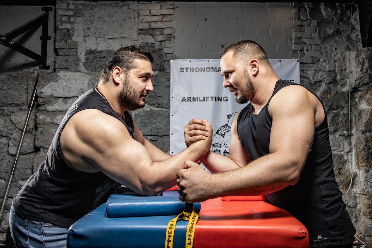 Two Pro Arm Wrestlers Arm Wrestling–image tries to explain Why OPS vs NPS Pension might lead Hottest #2024Election Drama