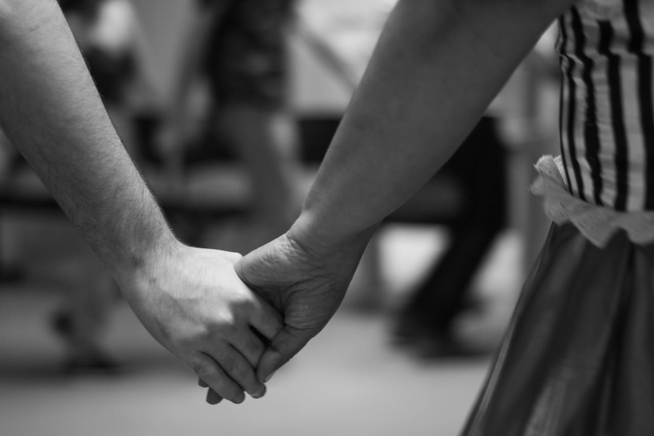 Black and white photo of couple holding hands - relates to Appreciating the Invisible: Wife Appreciation Day