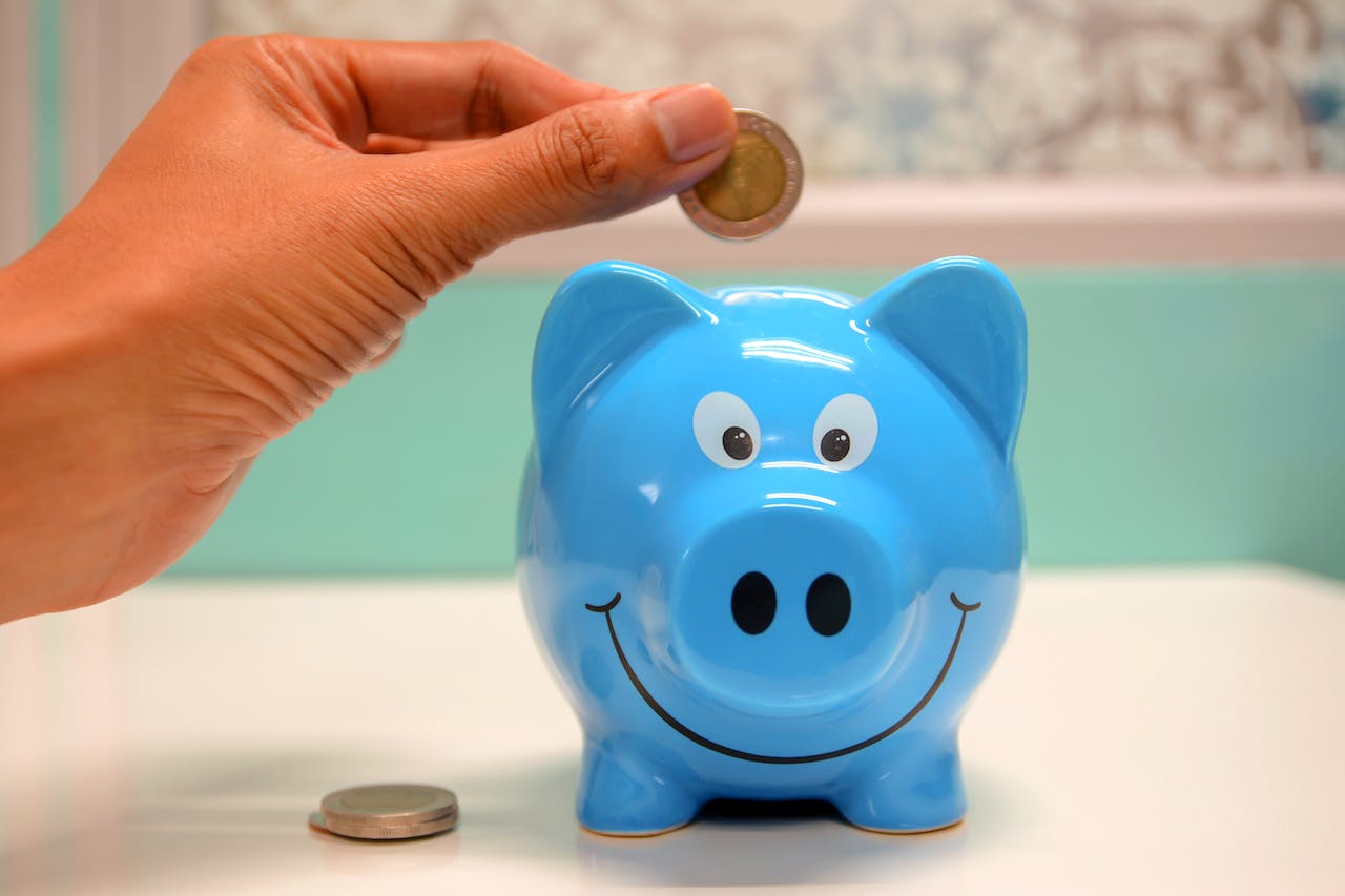 Person putting coin in a piggy bank - image tries to explain Multi Asset Allocation Funds, the real Investment Buffet
