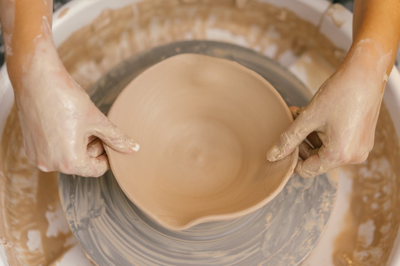 Person shaping clay bowl - relates to Funding Hobbies & Reigniting Old Passions for Pensioners: Guide to Retire/Recharge