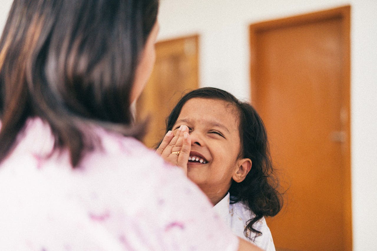 mother caressing her laughing daughter - Relates to Grow Your Daughters Wealth and Ambitions, Investments Strategies