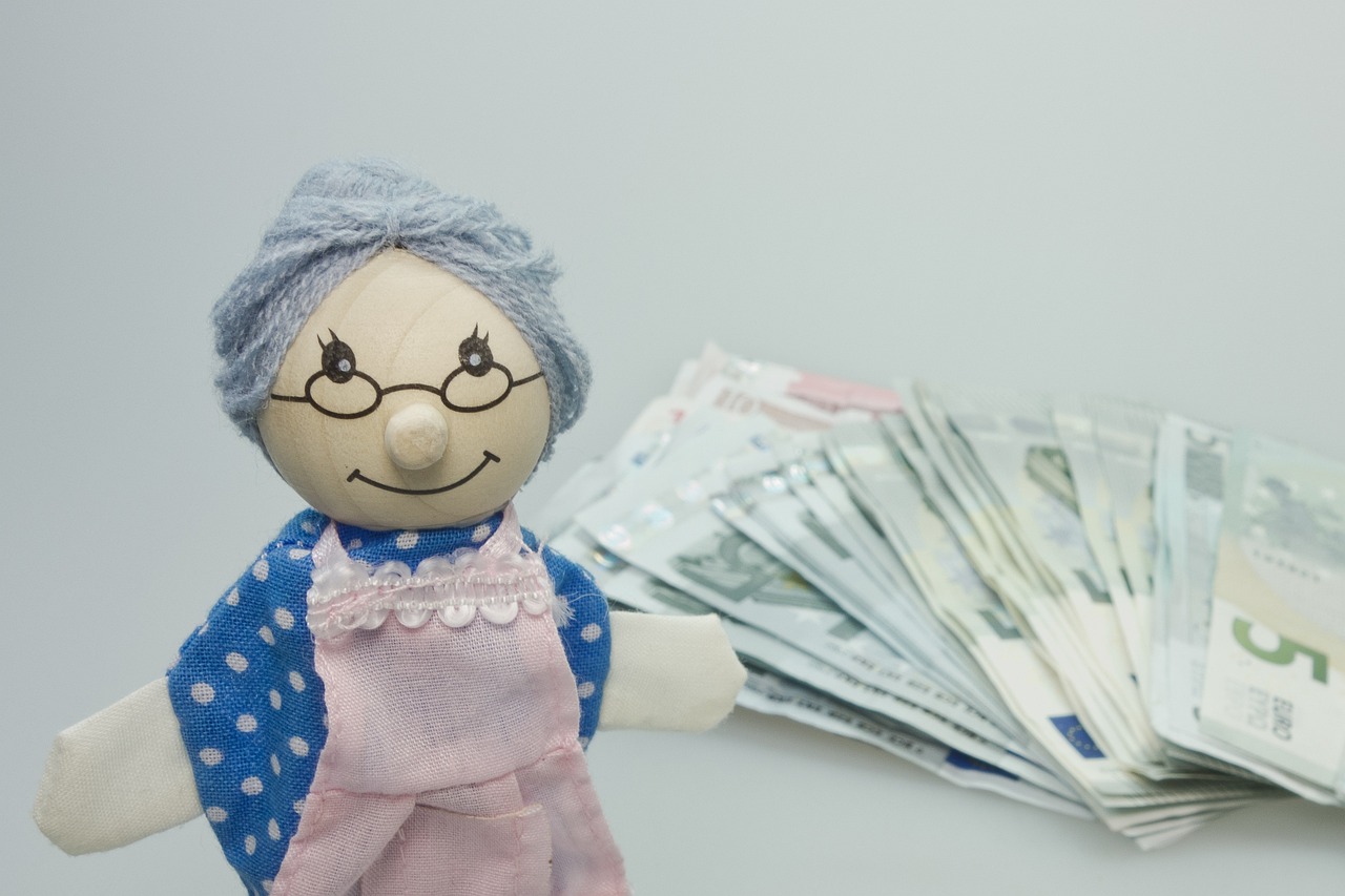 grandmother puppet with money behind her.