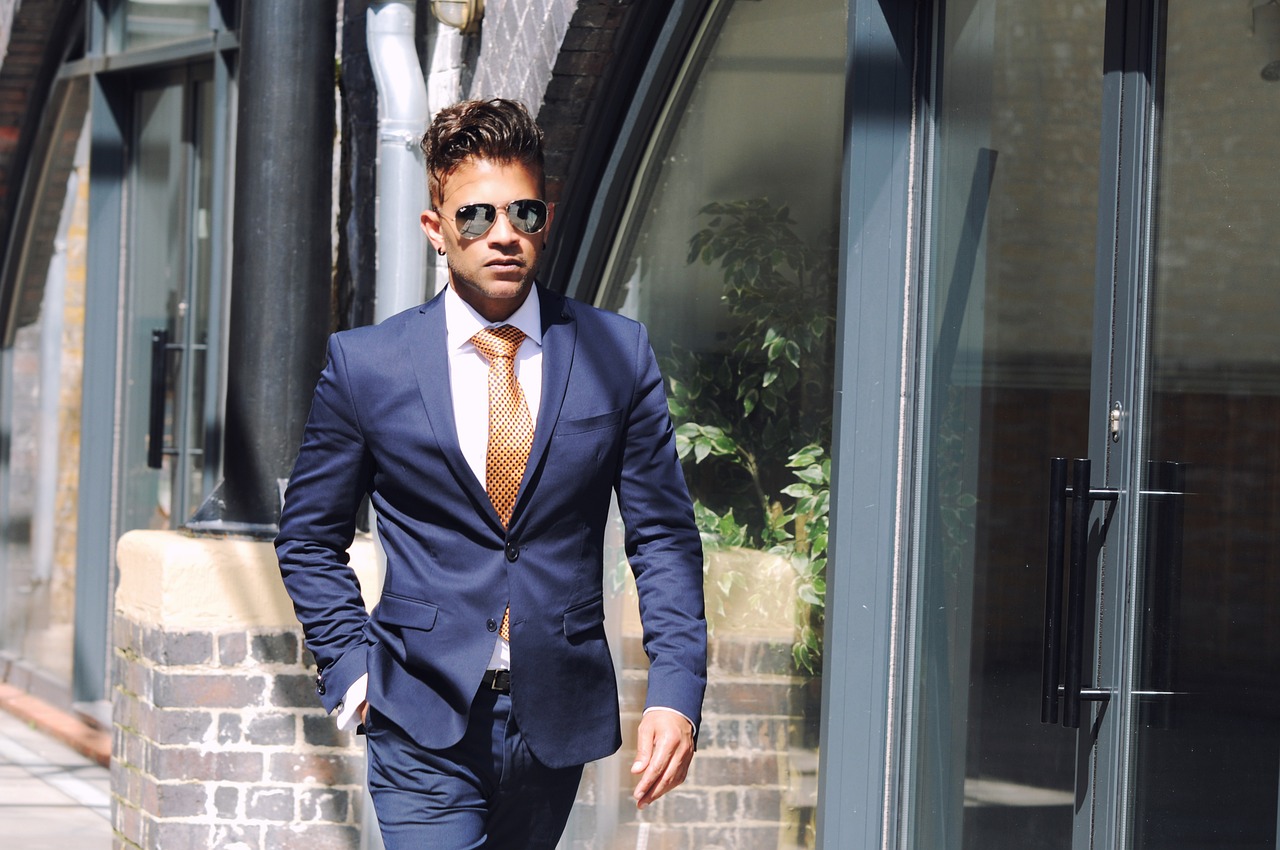 Man walking outside in business suit and glares