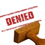 a ubber stamp with DENIED stamped