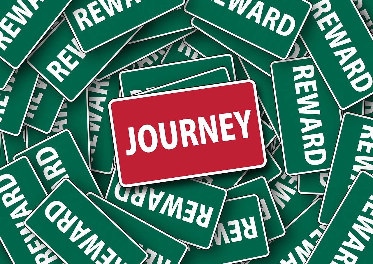 green sign boards titled reward, red board titled journey
