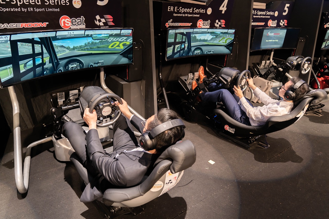 people sitting on a esport simulator playing a racing game – the image tries to explain the India's Esports Explosion