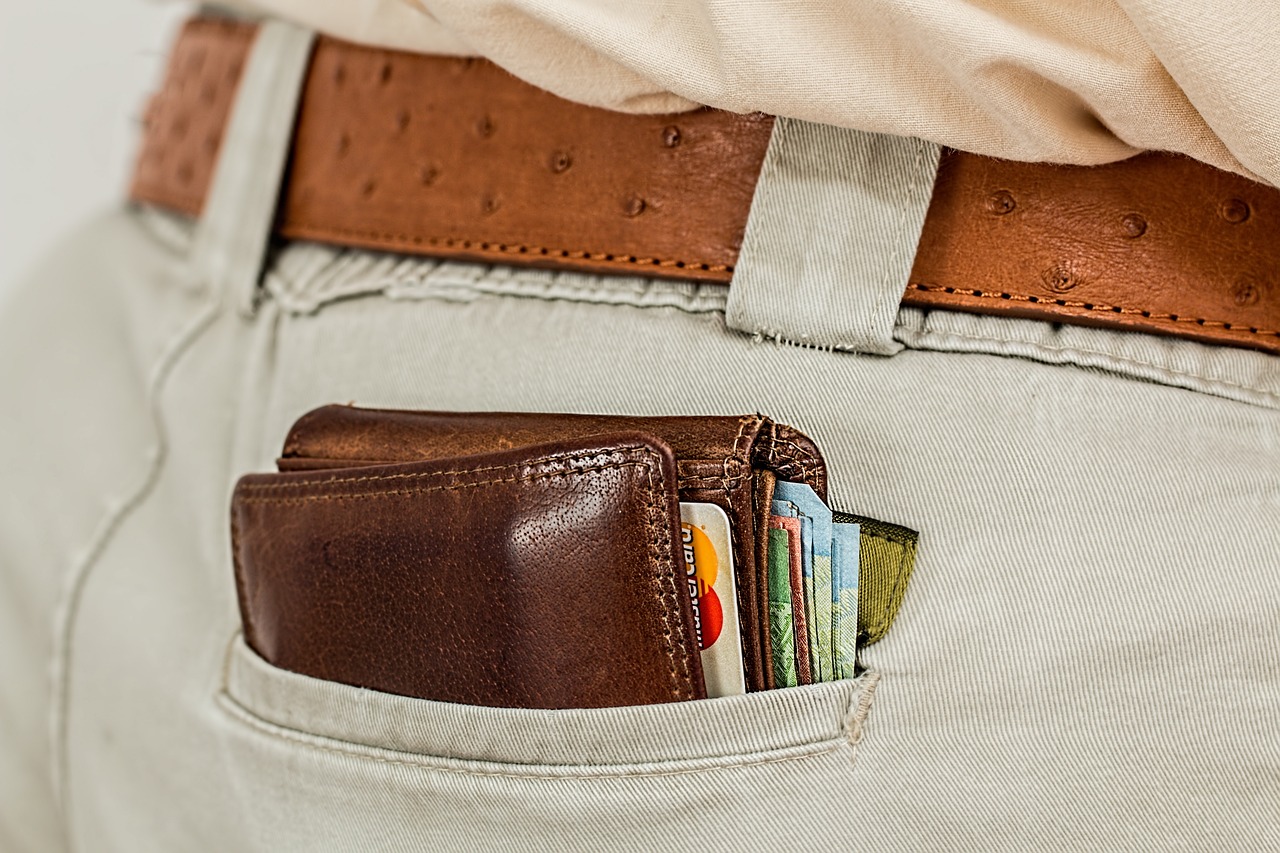 pant pocket of a man with a wallet full of credit cards