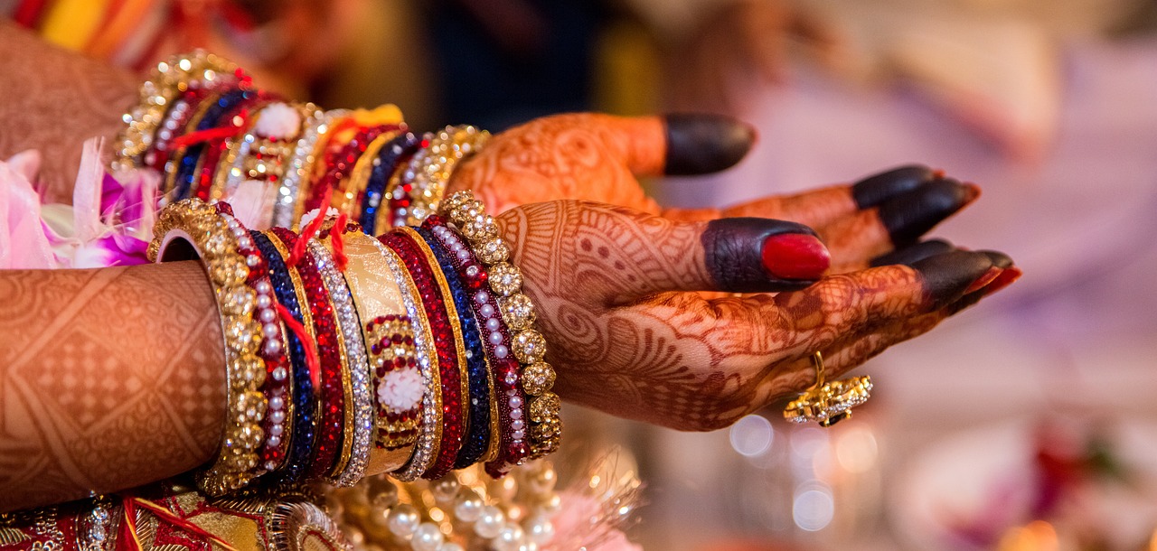 closeup of henna design of a Indian Brides hands - image tries to explain Must-Know Investment Ideas for Newlywed Women